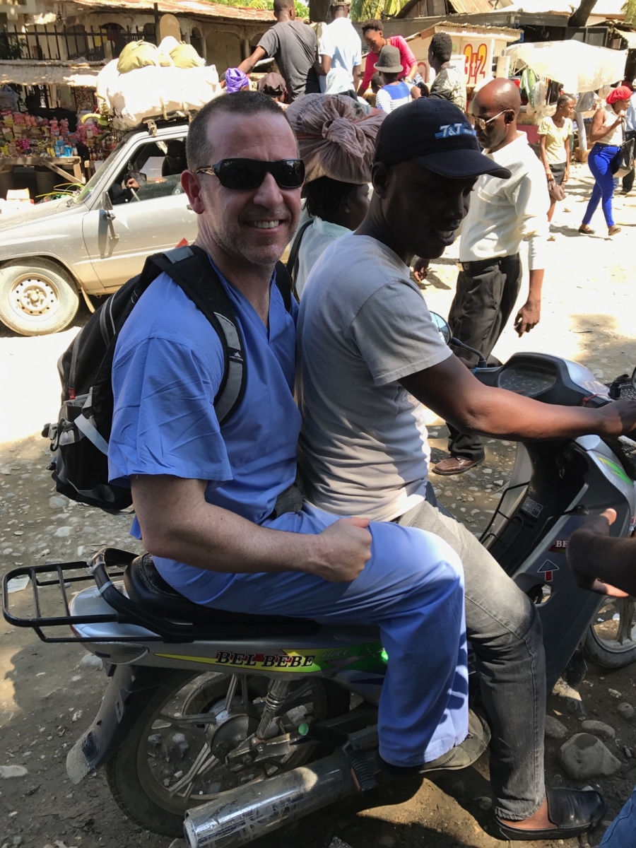 Dr. Cooper on a moped in Haiti